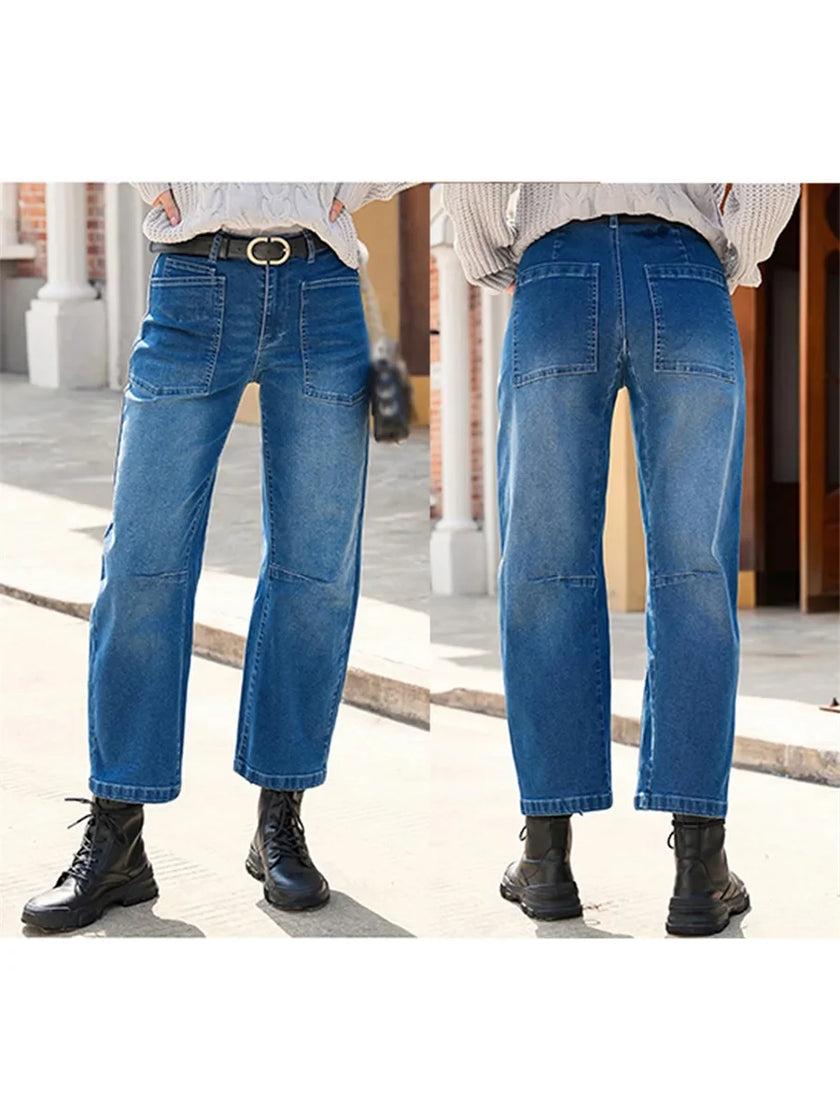 FJØRNA women's denim jeans with a barrel leg fit, showcasing a classic blue color and relaxed, stylish pant design.