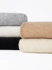 FJØRNA women's cashmere top featuring a soft, cozy knit design in a neutral color, perfect for stylish winter wear.