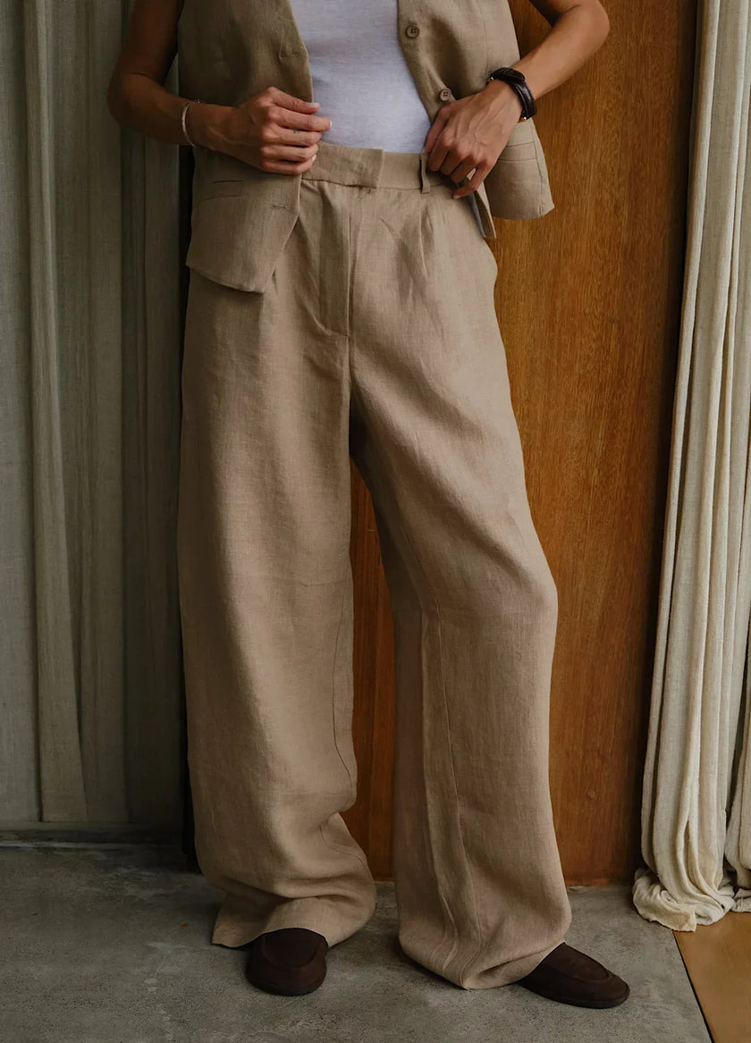 FJØRNA women's linen blend wide-leg high-waist trousers, stylish and comfortable pants for women, shown in natural fabric texture.