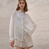 FJØRNA women’s linen shirt, lightweight and breathable top with a relaxed fit, shown in natural linen fabric.