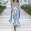 FJØRNA fitted off-shoulder mermaid midi dress with draped neckline and floral pattern, elegant evening wear for women