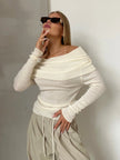Off-shoulder ribbed knit top for women by FJØRNA, shown in a close-up image highlighting the textured fabric and stylish design.