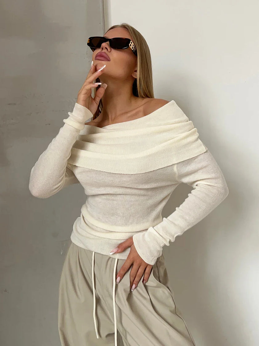 Off-shoulder ribbed knit top for women by FJØRNA, shown in a close-up image highlighting the textured fabric and stylish design.