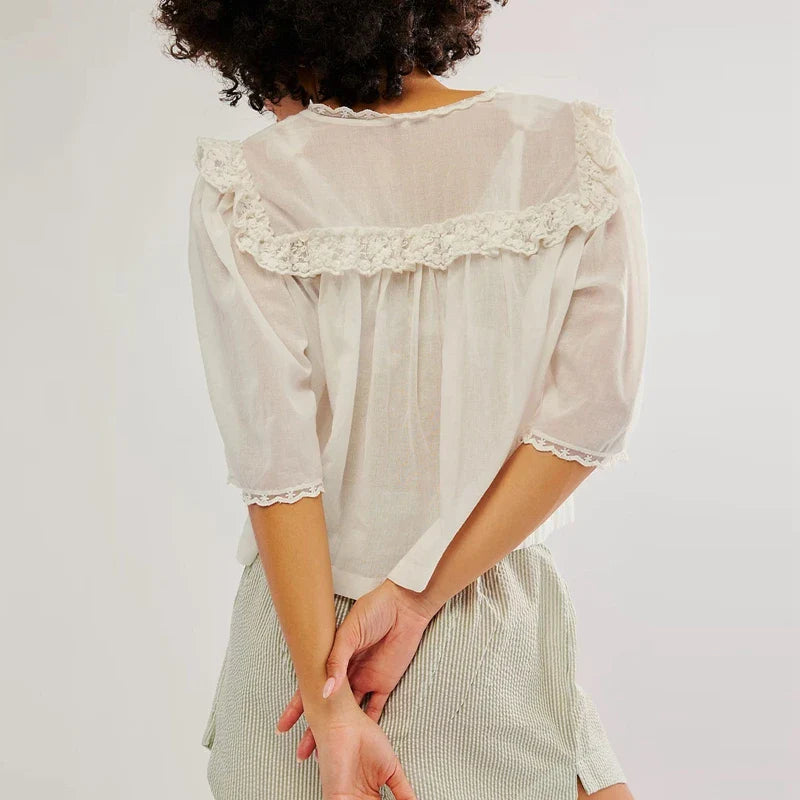 FJØRNA women's cotton blouse with ruffle details, featuring a stylish, feminine top in soft fabric and elegant design.