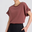 FJØRNA oversized tee with rolled cuffs, soft cotton fabric, relaxed fit, and casual style, shown on a model.