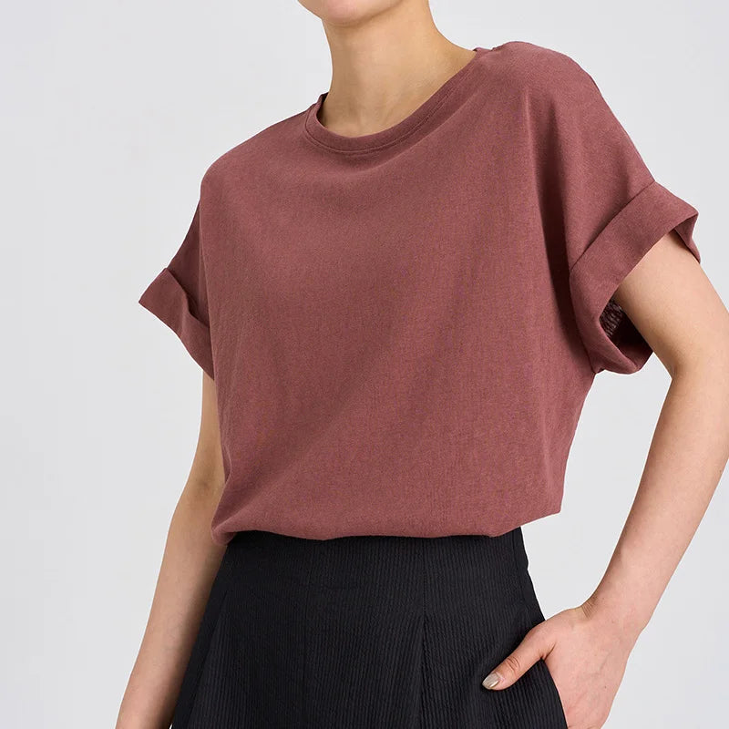 FJØRNA oversized tee with rolled cuffs, soft cotton fabric, relaxed fit, and casual style, shown on a model.