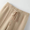 FJØRNA women's merino wool wide-leg high-waist trousers showing a tailored fit and soft, textured fabric.