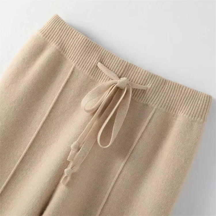 FJØRNA women's merino wool wide-leg high-waist trousers showing a tailored fit and soft, textured fabric.