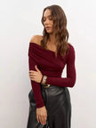 Women’s off-shoulder cotton top by FJØRNA featuring a relaxed fit and stylish design, shown on a model.