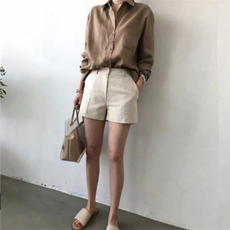 FJØRNA women's linen shirt with open collar, lightweight and breathable top, shown in a relaxed fit on a model.