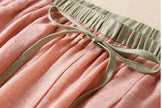 FJØRNA women's linen tapered trousers showing a relaxed fit, light fabric, and casual style perfect for warm weather.