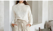 FJØRNA women's linen wide-leg trousers with elastic waist and ruffle details, shown on a model against a neutral background.