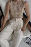 FJØRNA women's sleeveless knit tank top, lightweight and cozy, shown in a close-up of the soft, textured fabric.