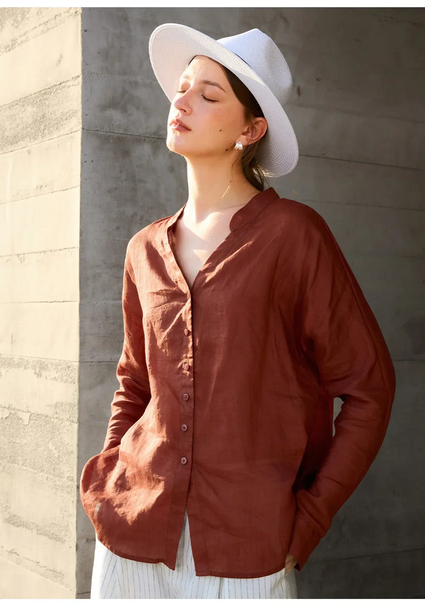 Women’s linen V-neck shirt by FJØRNA featuring lightweight, breathable fabric and a relaxed fit, shown in a natural pose.