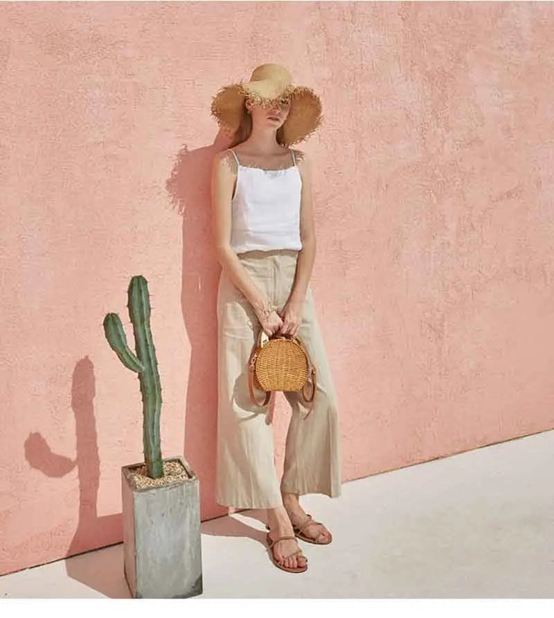 FJØRNA satin-trimmed linen camisole featuring a soft, flowy design with delicate satin accents and adjustable straps.