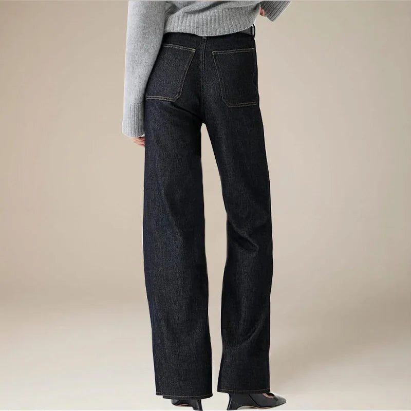 Women’s wide-leg cotton jeans by FJØRNA featuring high waist and relaxed fit, shown in a natural denim color.