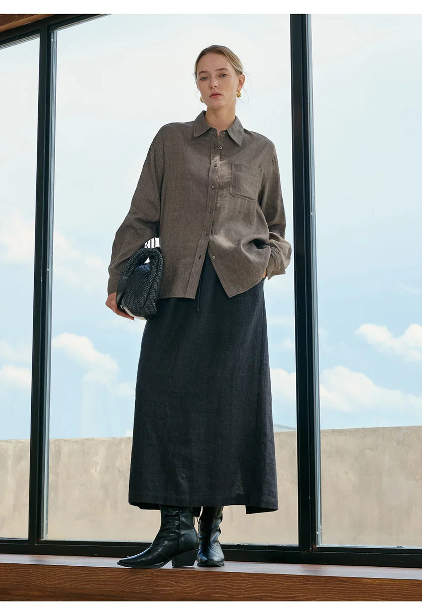 Women’s linen blend shirt by FJØRNA, featuring a relaxed fit and lightweight fabric, shown on a model with rolled-up sleeves.