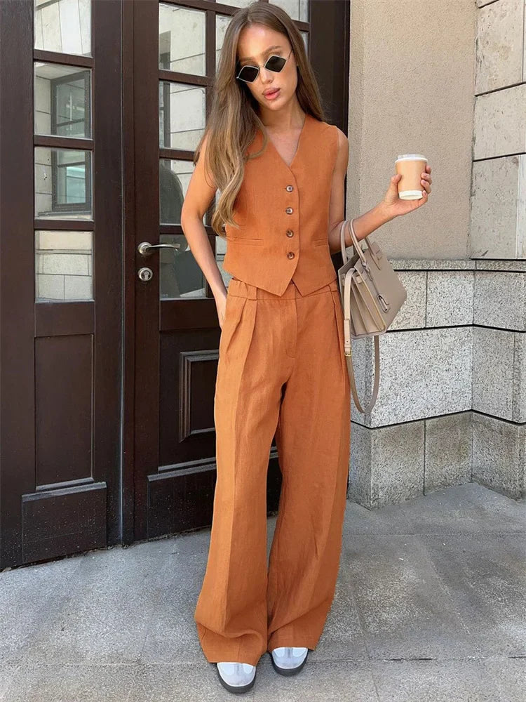 FJØRNA linen wide-leg trousers for women, part of a co-ord set, shown in a relaxed fit with a lightweight, breathable fabric.