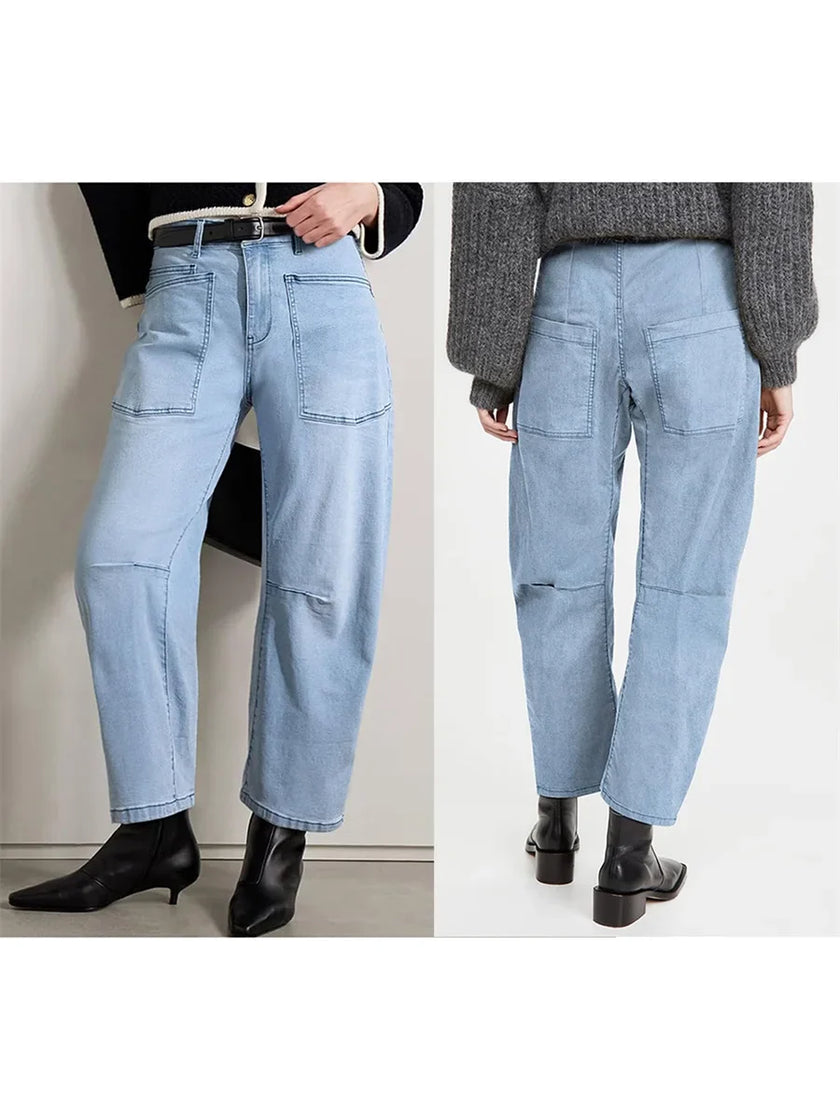 FJØRNA women's denim jeans with a barrel leg style, showcasing classic blue denim fabric and relaxed fit.