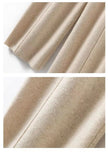 FJØRNA women's merino wool wide-leg high-waist trousers with a relaxed fit, shown in a stylish natural wool color.