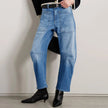 FJØRNA women's denim jeans with barrel leg style, showcasing classic blue pants with a relaxed fit and modern silhouette.