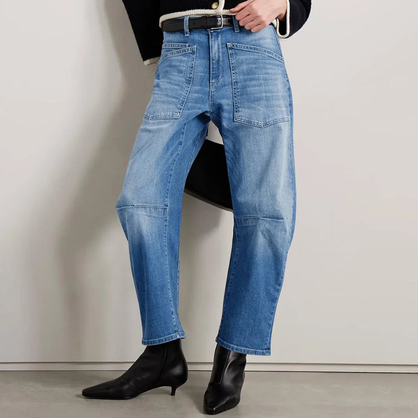 FJØRNA women's denim jeans with barrel leg style, showcasing classic blue pants with a relaxed fit and modern silhouette.