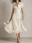 FJØRNA Zaffira Pleated Midi Dress in white, showcasing a flowy, pleated design perfect for elegant occasions.