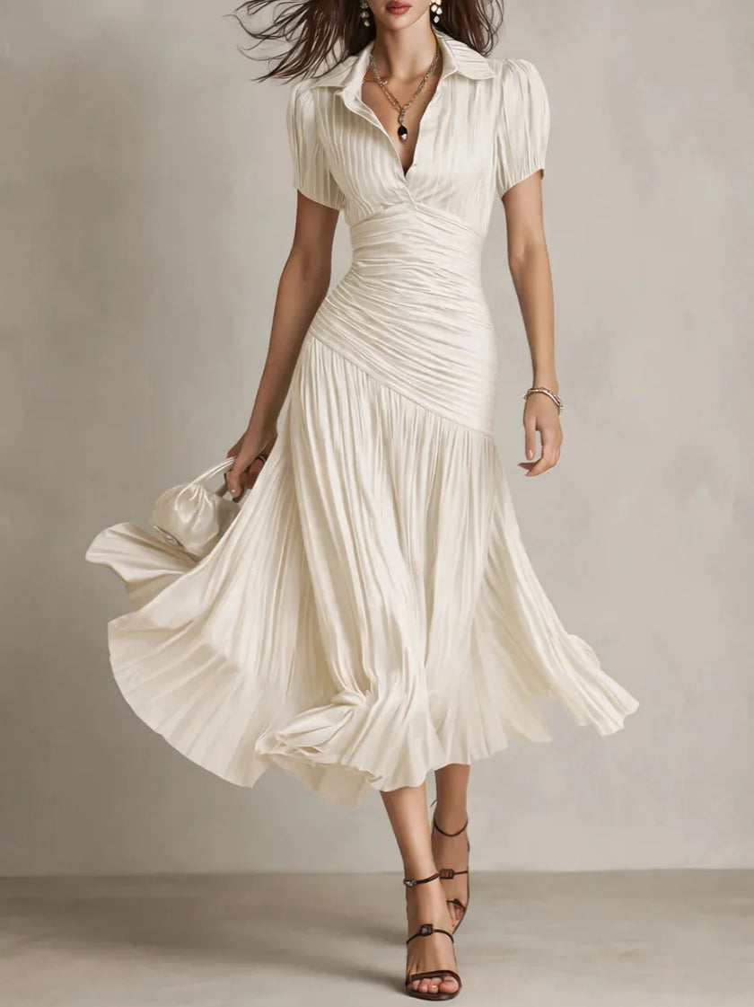 FJØRNA Zaffira Pleated Midi Dress in white, showcasing a flowy, pleated design perfect for elegant occasions.
