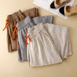 FJØRNA linen wide-leg women's trousers with drawstring waist, relaxed fit and lightweight fabric, perfect for casual wear.