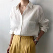 Women’s linen shirt with open collar by FJØRNA, lightweight and breathable top perfect for casual or summer wear.
