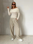 FJØRNA women's off-shoulder ribbed knit top, stylish and cozy, shown in a close-up image highlighting the ribbed fabric and off-shoulder design.