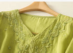 Women’s cotton blouse by FJØRNA with a V-neck, featuring soft fabric and stylish design for casual or office wear.