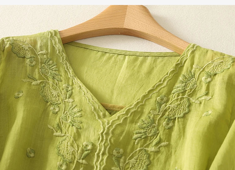 Women’s cotton blouse by FJØRNA with a V-neck, featuring soft fabric and stylish design for casual or office wear.