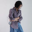 FJØRNA women's linen shirt with pleated design, long sleeves, and a relaxed fit, shown on a model.