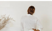 FJØRNA linen women's top with ruffle details, lightweight and stylish, perfect for casual or dressy wear.