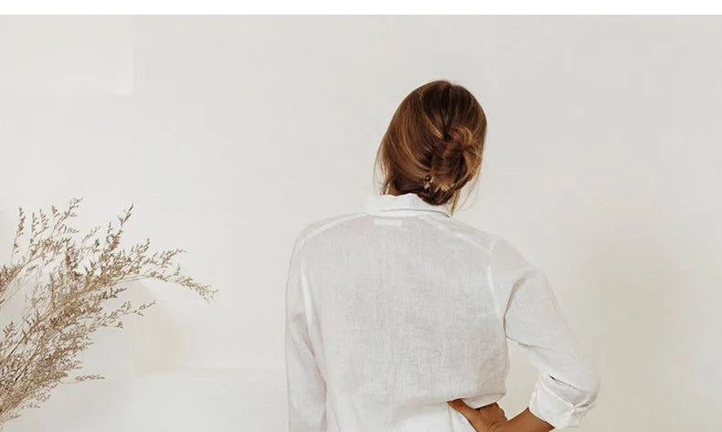 FJØRNA women's linen wide-leg trousers with elastic waist and ruffle detail, styled for a relaxed, elegant look.