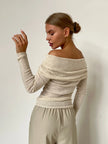 FJØRNA women's off-shoulder ribbed knit top with fitted design and long sleeves, shown in a close-up view.