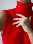 FJØRNA women's sleeveless wool vest, soft and warm tops, shown in a neutral color on a model.