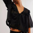 FJØRNA women's cotton blouse with ruffle detail, featuring a stylish and comfortable top for women.