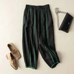 FJØRNA women's linen wide-leg trousers with elastic waist, showing relaxed fit and lightweight fabric in a natural pose.