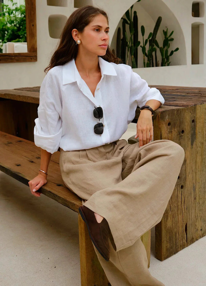 Women's linen blend wide-leg trousers by FJØRNA with high waist and relaxed fit, shown in a natural fabric and stylish cut.