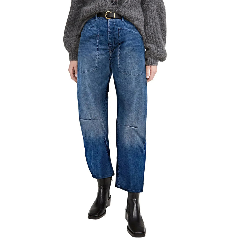 FJØRNA women's denim jeans with a barrel leg fit, showcasing classic blue denim, high-rise waist, and relaxed silhouette.