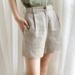 FJØRNA women's high waist linen shorts, lightweight pants with a relaxed fit and natural beige fabric, suitable for warm weather.