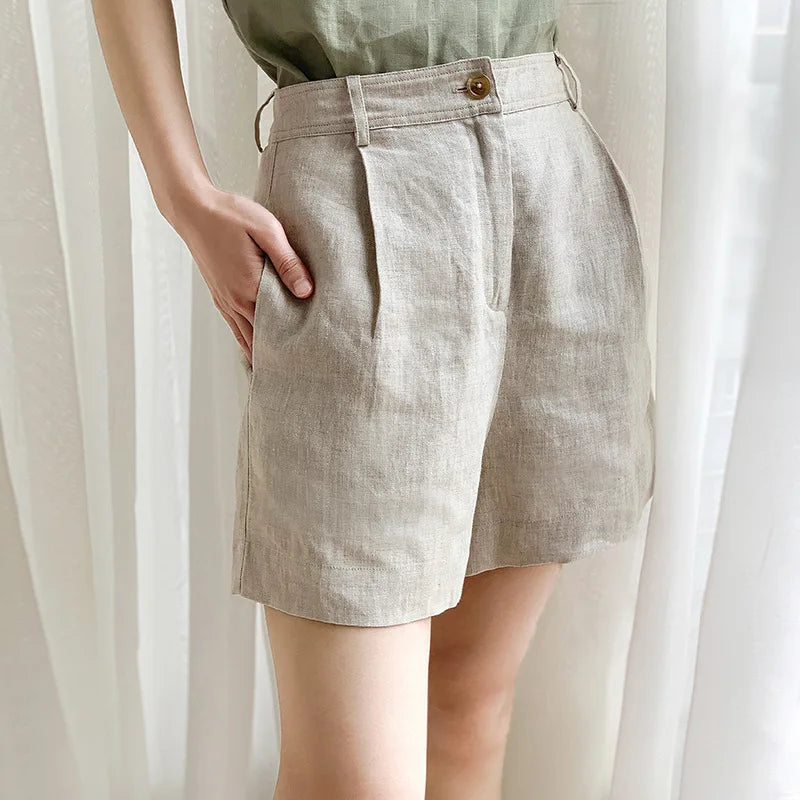 FJØRNA women's high waist linen shorts, lightweight pants with a relaxed fit and natural beige fabric, suitable for warm weather.