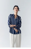Lacceti Maren Stripe Satin Blouse in white and navy with long sleeves and a classic collar, shown on a hanger.
