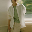FJØRNA linen shirt with slit hem detail, lightweight and breathable, shown in a natural relaxed fit style.