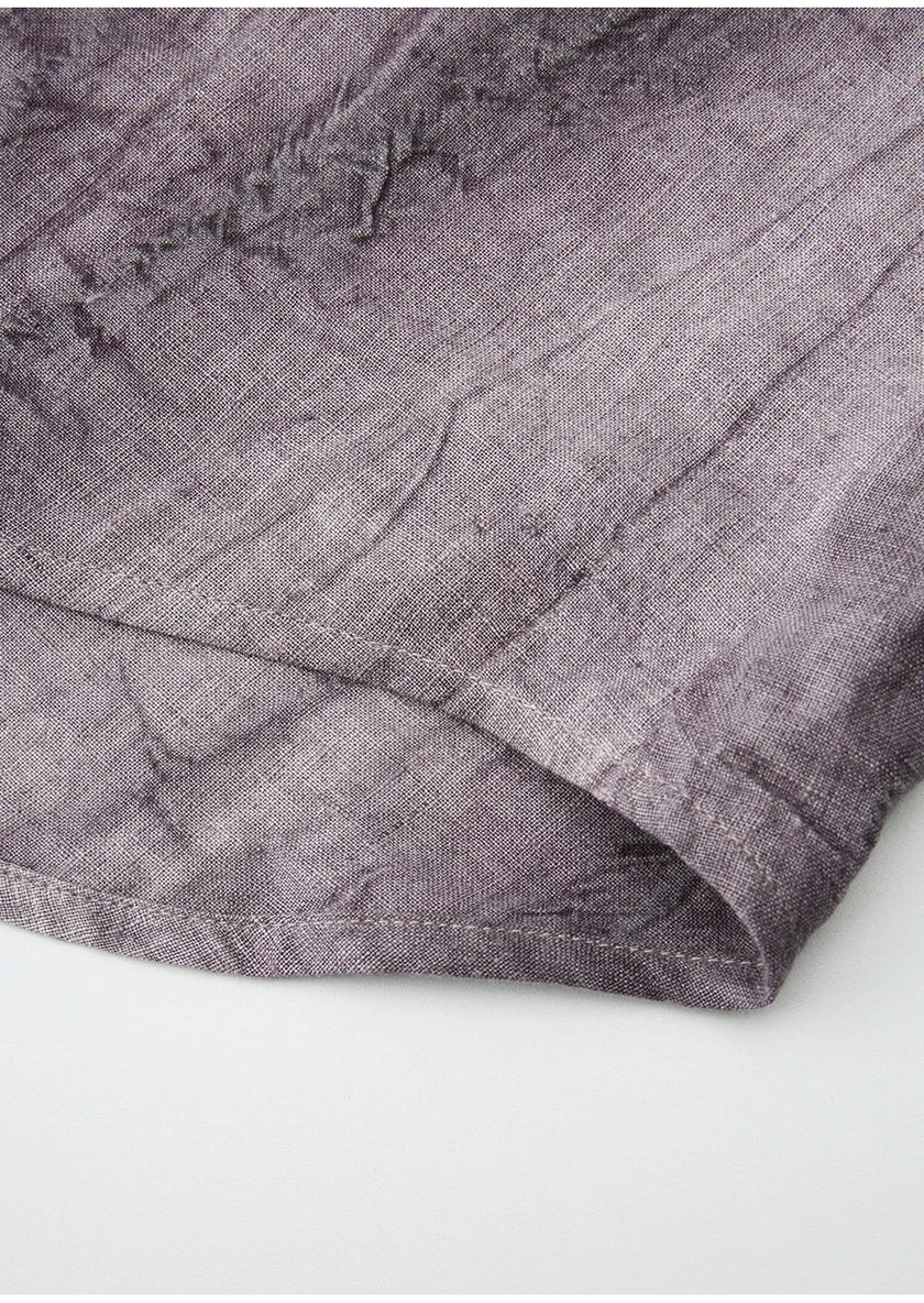 FJØRNA women's linen shirt with pleated design, long sleeves, and a relaxed fit, showcasing the lightweight, breathable fabric.