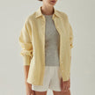 FJØRNA linen shirt with slit hem detail, lightweight, breathable fabric, casual fit, shown on a model.