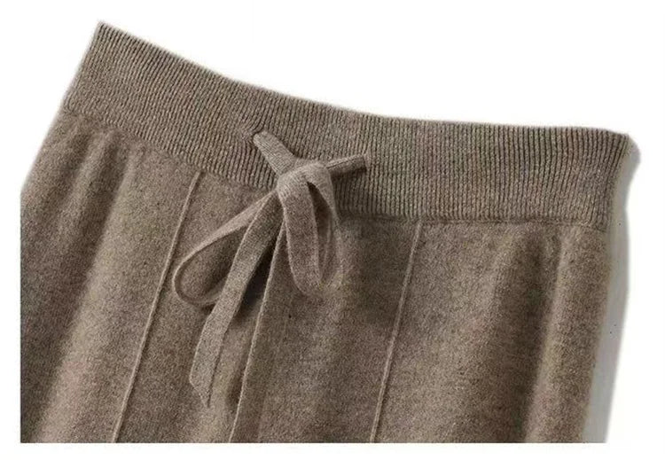 FJØRNA women's merino wool wide-leg high-waist trousers, stylish and comfortable pants with a sleek fit, shown in a natural fabric appearance.
