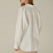 FJØRNA linen shirt with slit hem detail, featuring a relaxed fit and lightweight fabric for casual stylish wear
